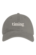 Gray vintage washed dad hat with ivory "timing" embroidery on the front.