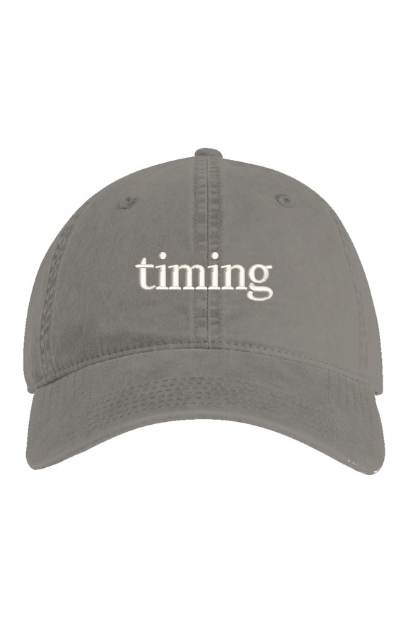 Gray vintage washed dad hat with ivory "timing" embroidery on the front.