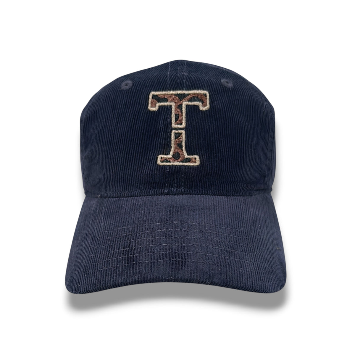 Atlas navy corduroy cap with leopard-print Threshold T embroidery, a cream outline, and an intentional center gap, shown from the front on white.