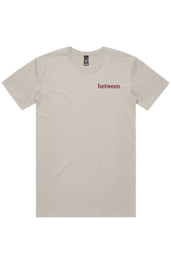 Cream cotton T-shirt featuring "between" embroidered in burgundy script on the left chest.