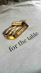 Close-up of the sardine tin graphic and "for the table" text on a Sea Glass t-shirt.