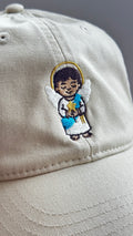 Close-up of the Light Guardian angel embroidery on a beige dad hat
