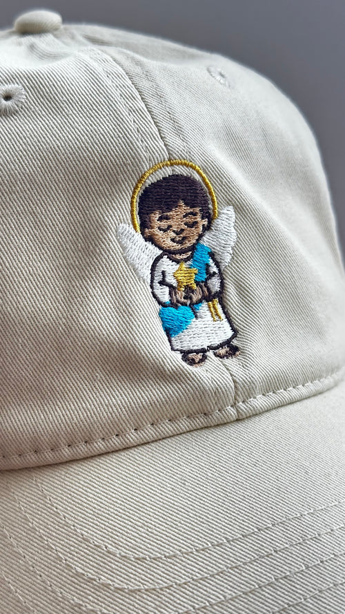 Close-up of the Light Guardian angel embroidery on a beige dad hat