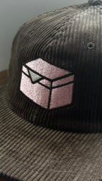 Brown corduroy hat embroidered with a pink donut box icon.