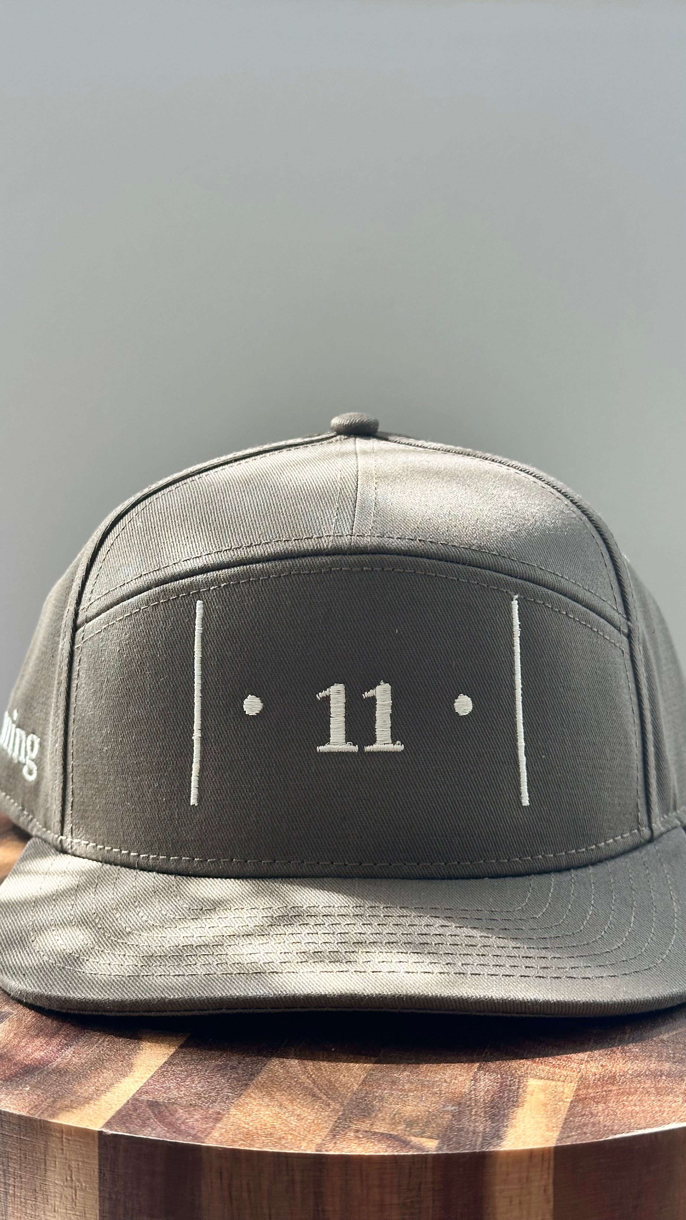 Front view of The Passage Mark™ structured cap in Rooted featuring the embroidered │ • 11 • │ symbol in white thread
