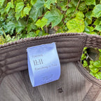 Interior view of a brown corduroy hat featuring the Timing 11:11 signature label.