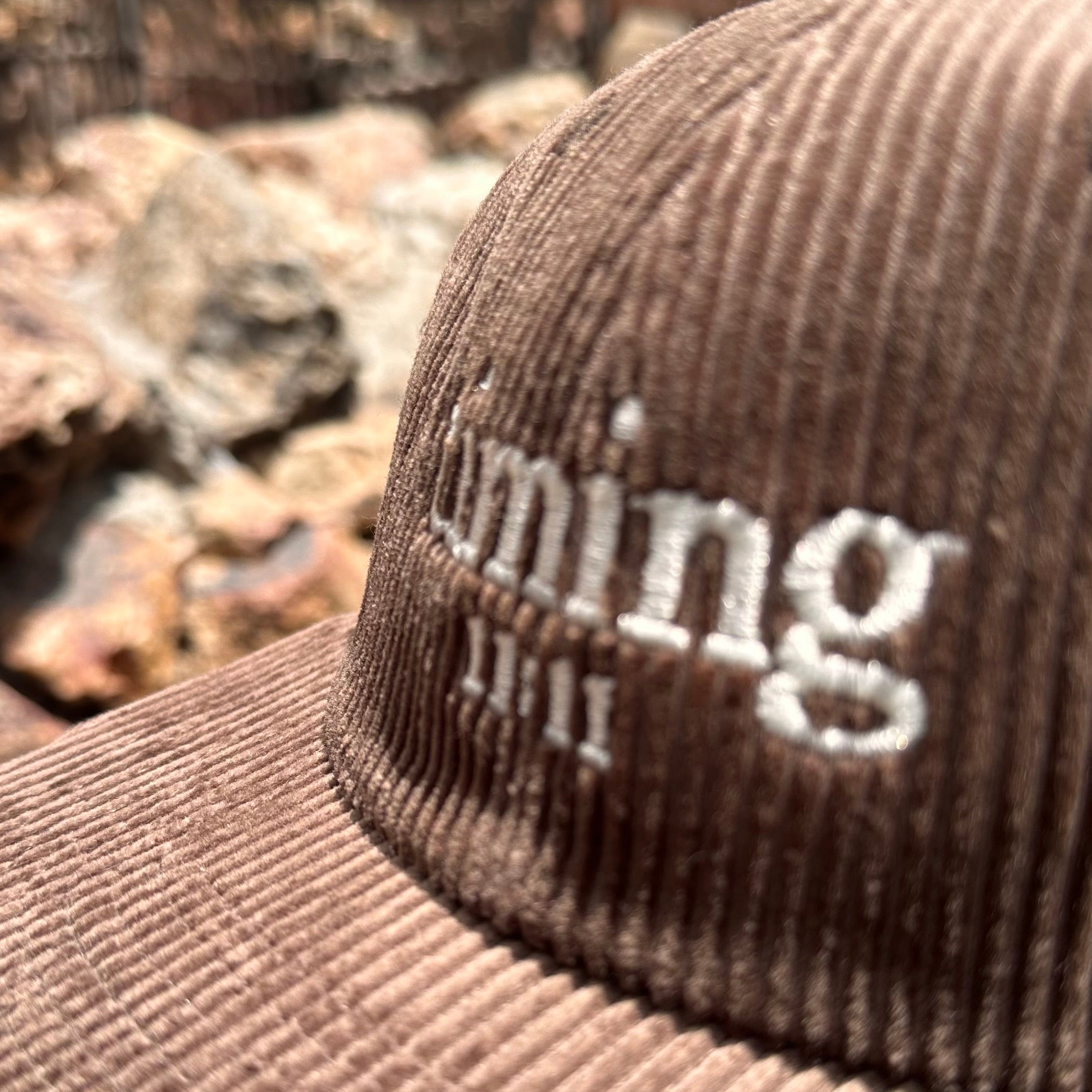 Close-up showcasing the corduroy texture and embroidered "timing 11:11" logo.